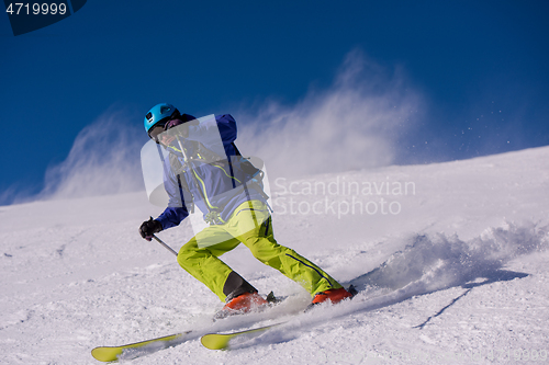 Image of Skier having fun while running downhill