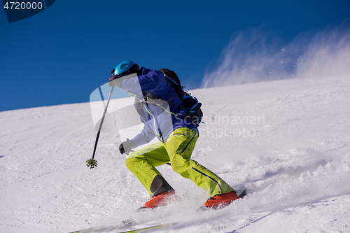 Image of Skier having fun while running downhill