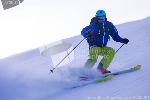 Image of Skier having fun while running downhill