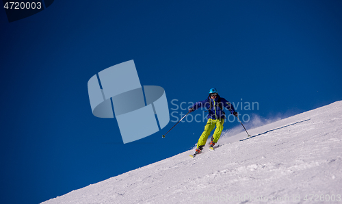 Image of Skier having fun while running downhill