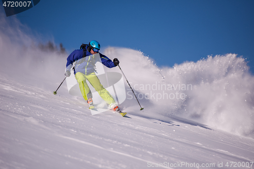 Image of Skier having fun while running downhill