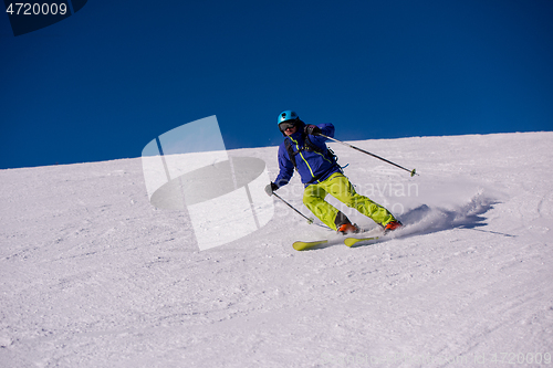 Image of Skier having fun while running downhill