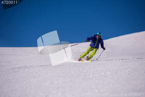 Image of Skier having fun while running downhill