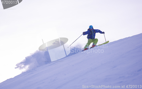 Image of Skier having fun while running downhill