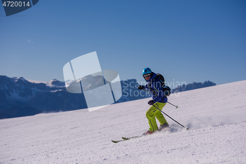 Image of Skier having fun while running downhill