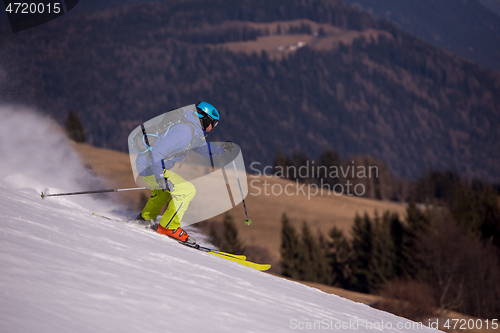 Image of Skier having fun while running downhill