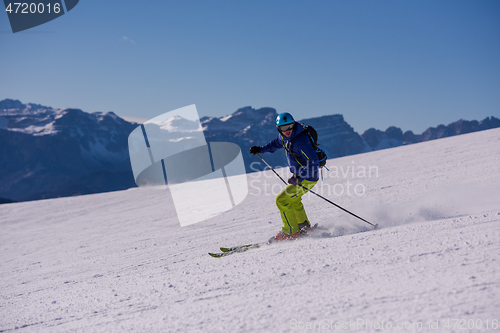 Image of Skier having fun while running downhill