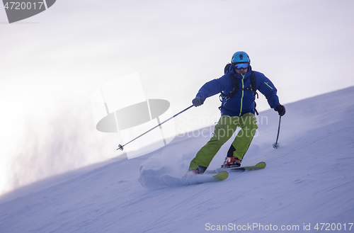 Image of Skier having fun while running downhill