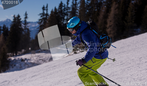 Image of Skier having fun while running downhill