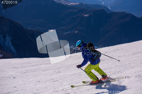 Image of Skier having fun while running downhill