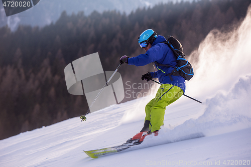 Image of Skier having fun while running downhill