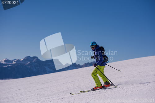 Image of Skier having fun while running downhill