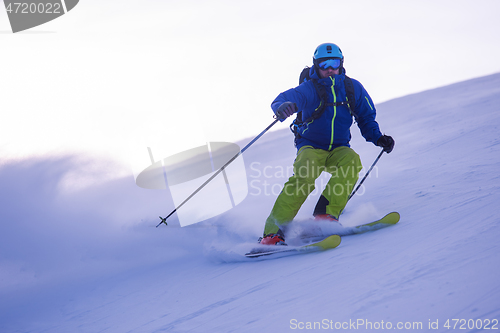 Image of Skier having fun while running downhill