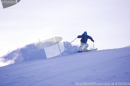 Image of Skier having fun while running downhill