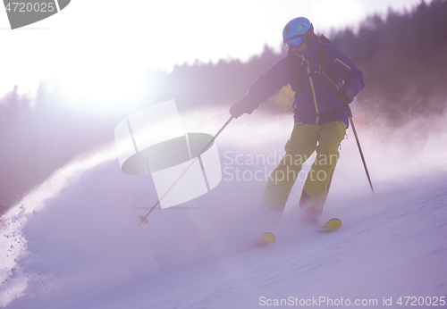 Image of Skier having fun while running downhill