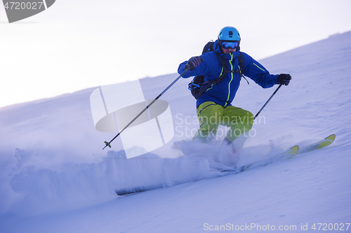 Image of Skier having fun while running downhill