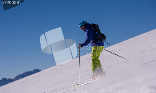 Image of Skier having fun while running downhill