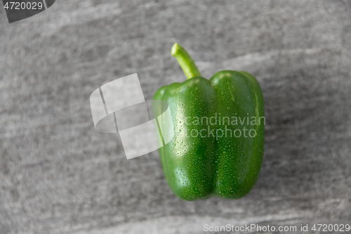 Image of close up of green pepper on slate stone background