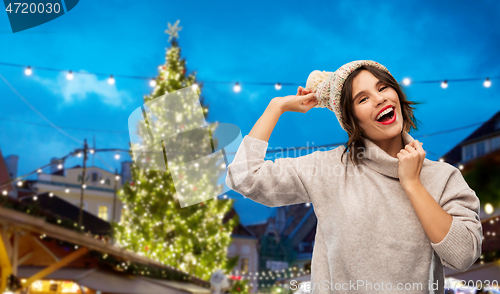 Image of woman in hat and sweater at christmas market