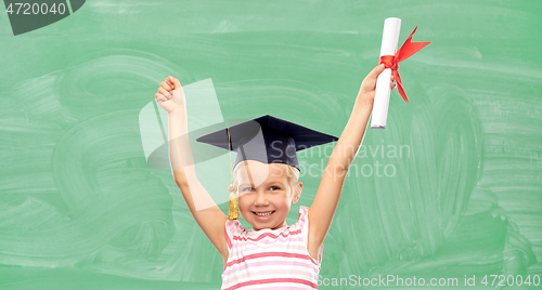 Image of happy little girl in mortarboard with diploma