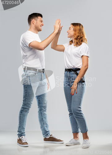 Image of happy couple making high five gesture