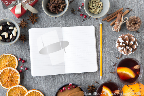 Image of notebook, pencil and hot mulled wine on christmas