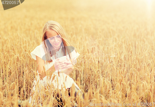 Image of happy woman with smartphone and earphones