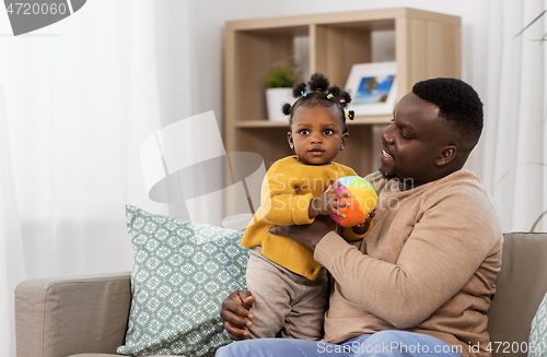 Image of happy african american father with baby at home