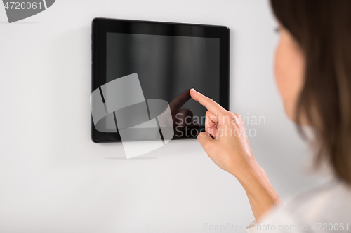 Image of woman using tablet computer at smart home