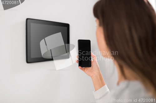 Image of woman using tablet computer and smartphone