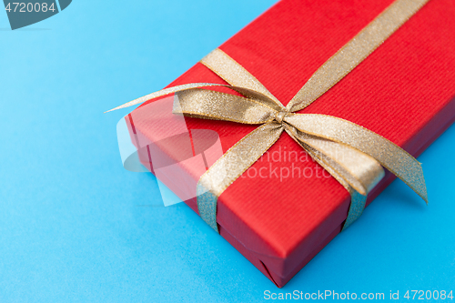Image of christmas red gift box on blue background