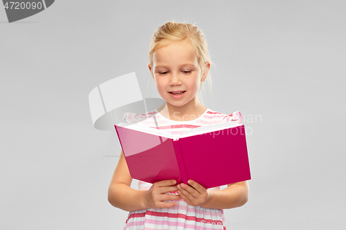 Image of smiling little girl reading book