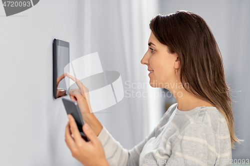 Image of woman using tablet computer and smartphone
