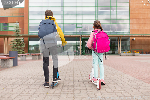 Image of school children with backpacks and scooters