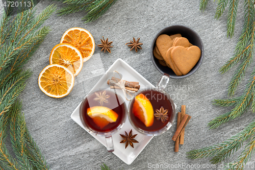 Image of mulled wine, orange slices, gingerbread and spices