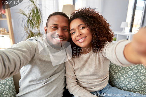 Image of african american couple taking selfie at home