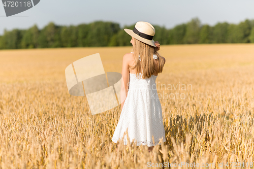 Image of portrait of girl in straw hat on field in summer