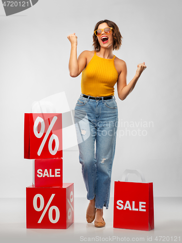 Image of happy smiling young woman with shopping bags