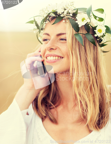 Image of happy young woman calling on smartphone at country