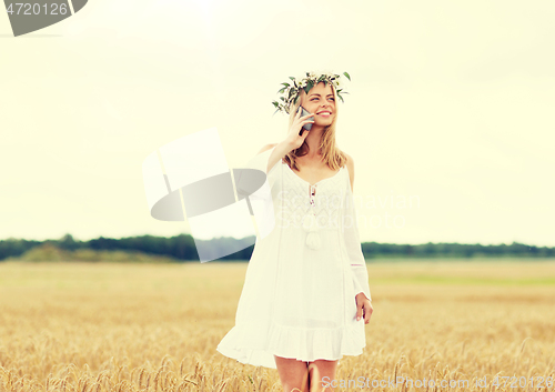 Image of happy young woman calling on smartphone at country