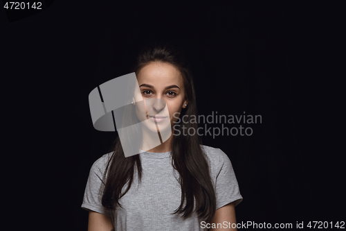 Image of Close up portrait of young woman isolated on black studio background