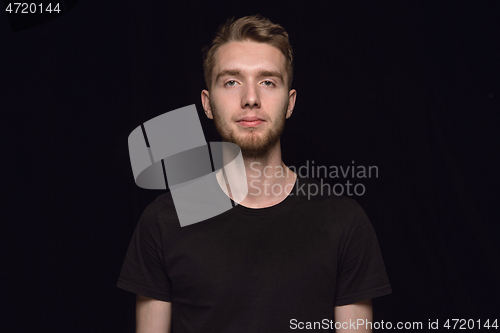 Image of Close up portrait of young man isolated on black studio background