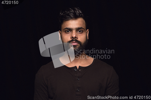 Image of Close up portrait of young man isolated on black studio background