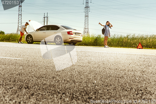 Image of Young couple traveling on the car in sunny day