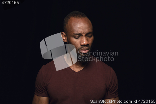 Image of Close up portrait of young man isolated on black studio background