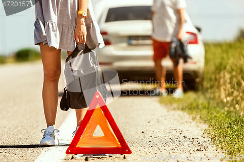 Image of Young couple traveling on the car in sunny day