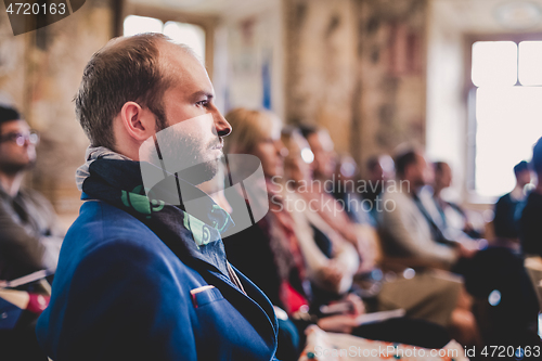 Image of Entrepreneur in audience at business conference.