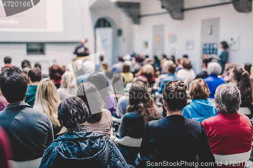 Image of Man giving presentation in lecture hall at university.