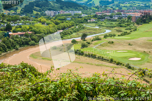 Image of Aerial view to the river, golf field and city on a beautiful summer day