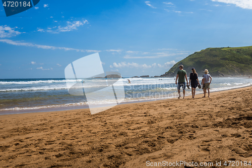 Image of ZARAUTZ, SPAIN- JULY 11, 2020: View to the Zarautz Beach with walking people, Basque Country, Spain on a beautiful summer day